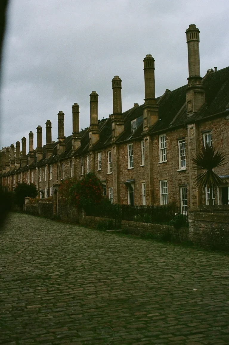 Row of period brick houses with tall chimneys