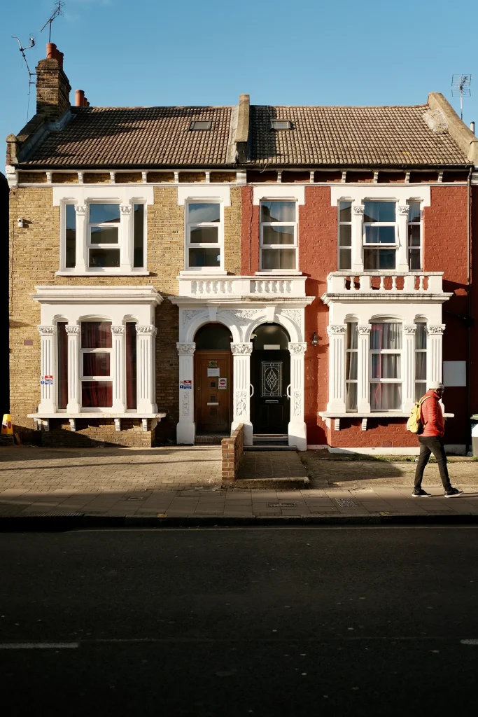 Period townhouse with a white portico entrance